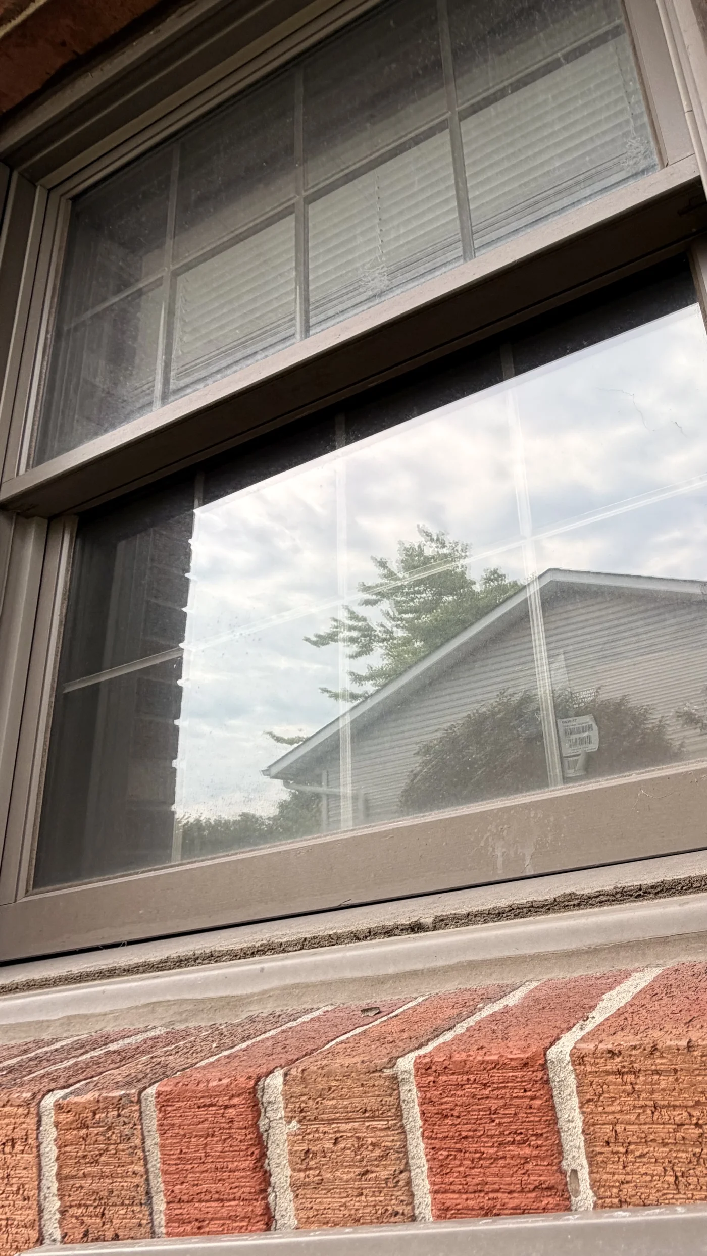 Exterior brick home window before cleaning in Middletown, Ohio showing grime and buildup